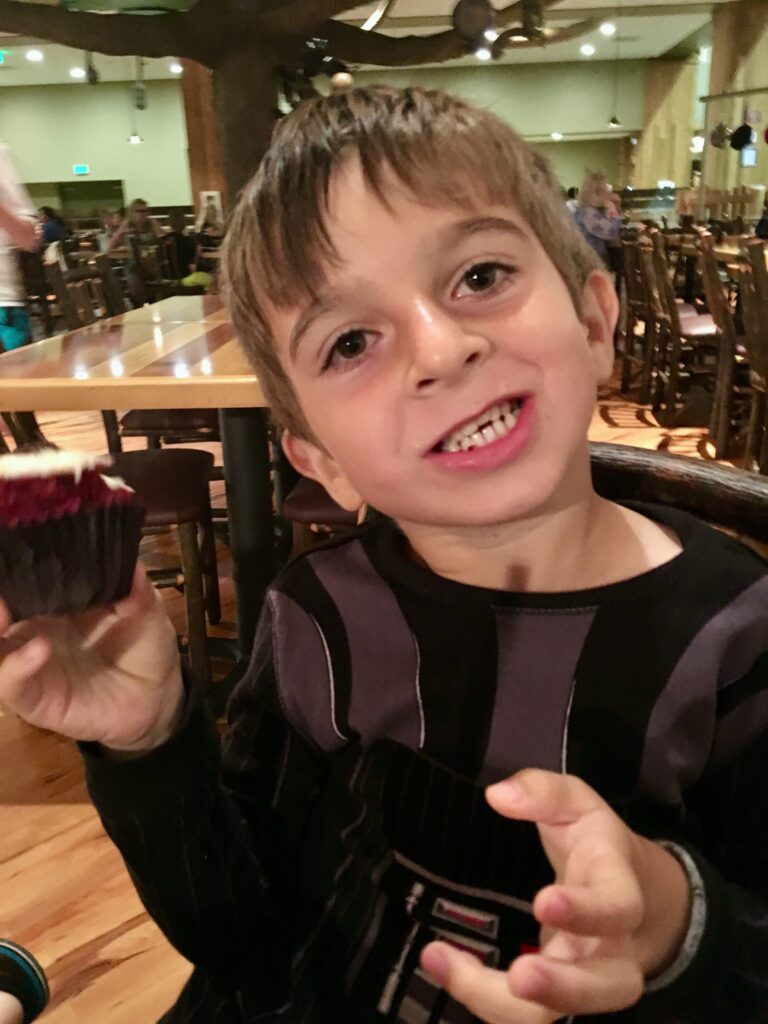 boy smiling with cupcake