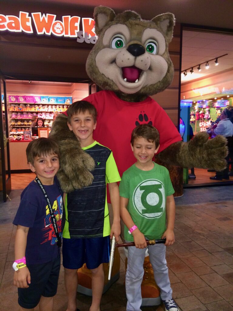 three boys with wolf mascot