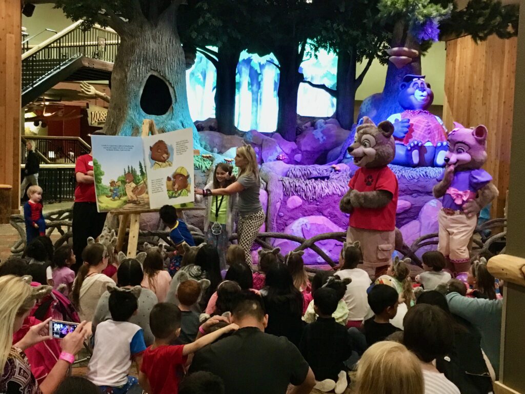 storytime with mascots surrounded by sitting families