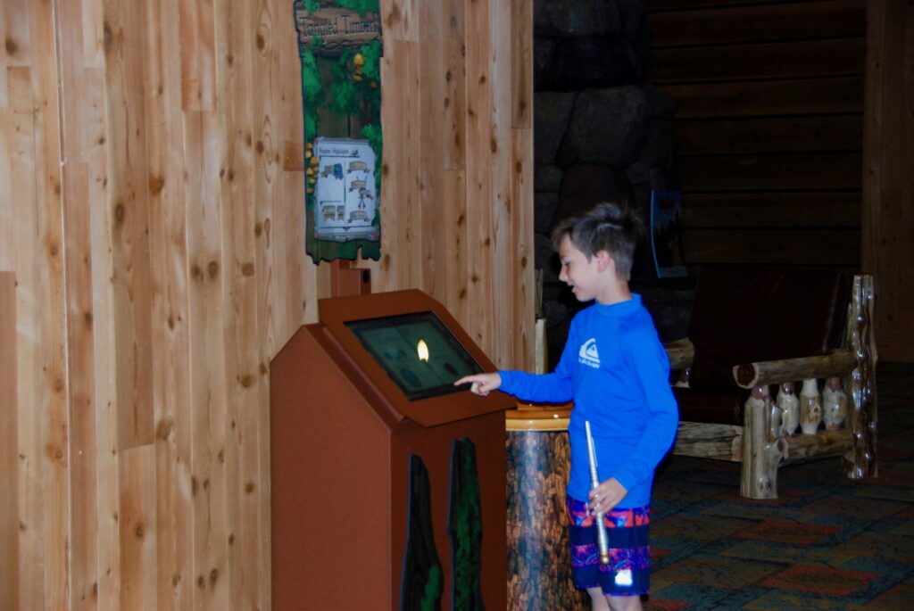 boy with wand at kiosk