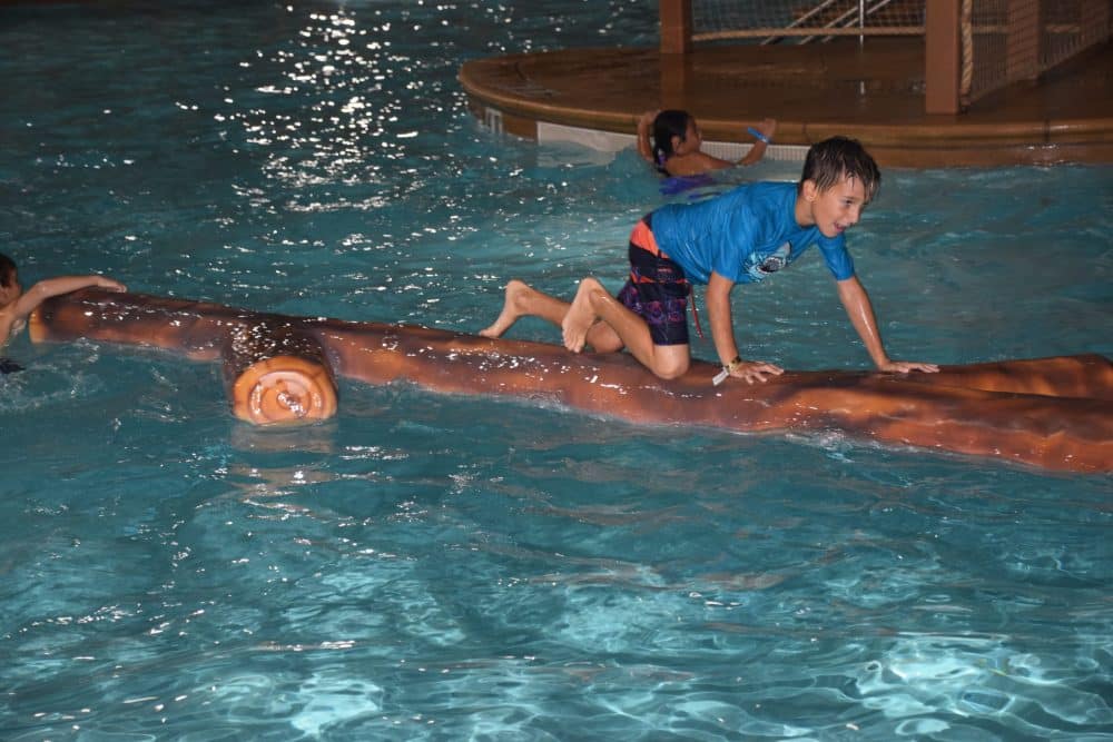 boy climbing on fake log - Great Wolf Lodge Spooktacular
