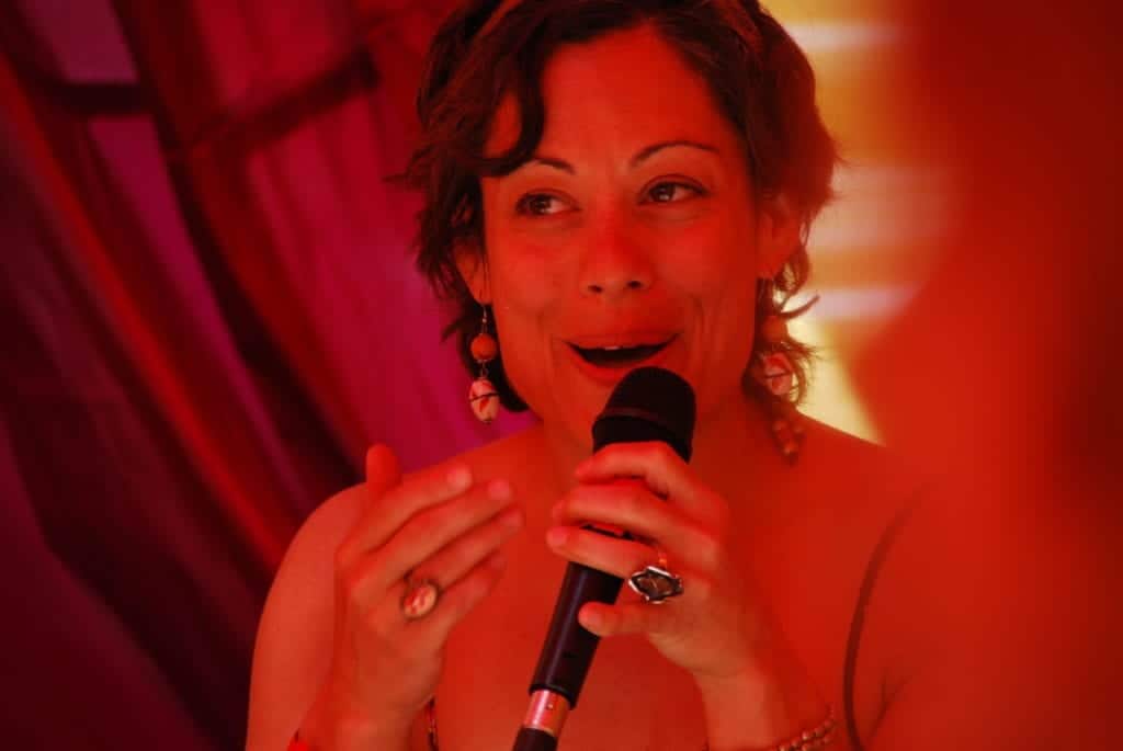 women speaking into microphone- Finding Your Alternate Universe at Shakti Fest