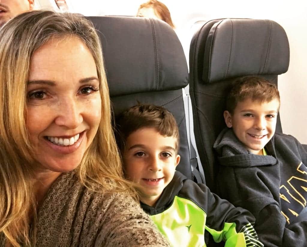 Mom taking selfie with her kids - 7 Ways to Survive Traveling With Babies and Kids
