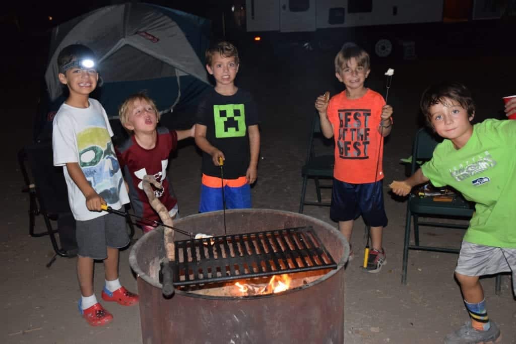 Kids making smores - 7 Ways to Survive Traveling With Babies and Kids