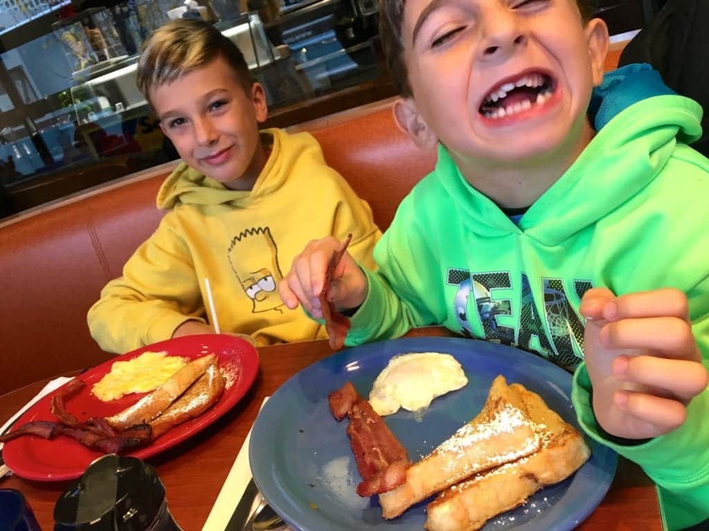 Kids eating breakfast - 7 Ways to Survive Traveling With Babies and Kids