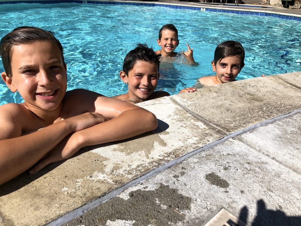 four boys in pool - Hyatt Regency Westlake staycation