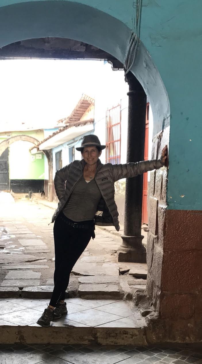 Standing in an archway in Cusco, Peru - 7 Tips for Traveling with Girlfriends