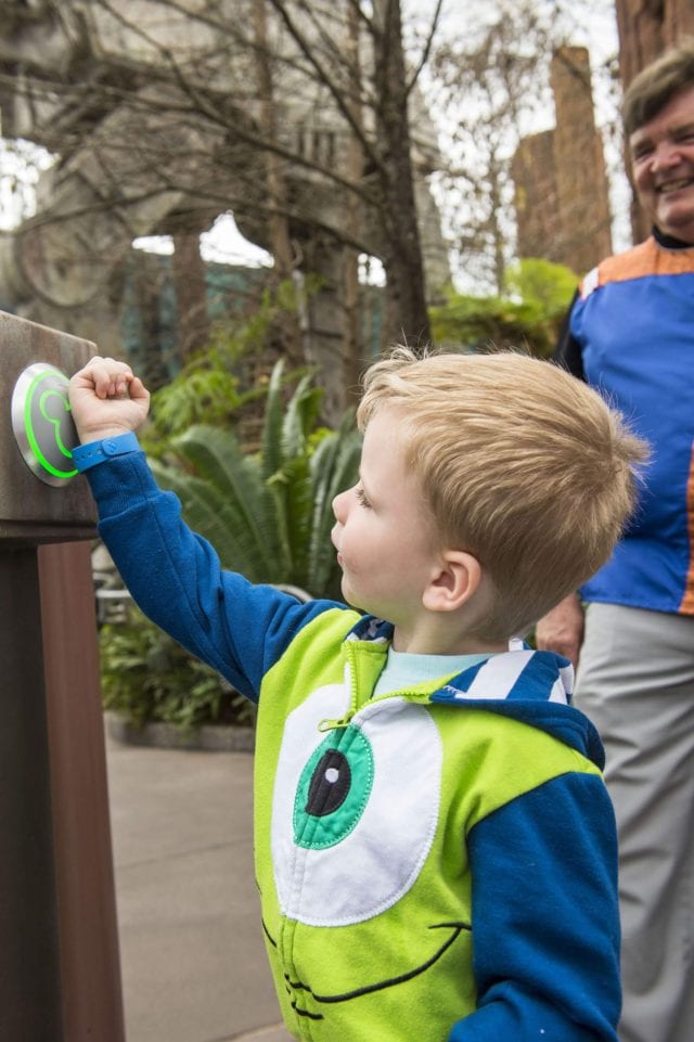 boy using MagicBands for FastPass+ at Disney - photo Credit Matt Stroshane/Walt Disney World Resort - Cutting the Line: A How To Guide For Your Fav Theme Park