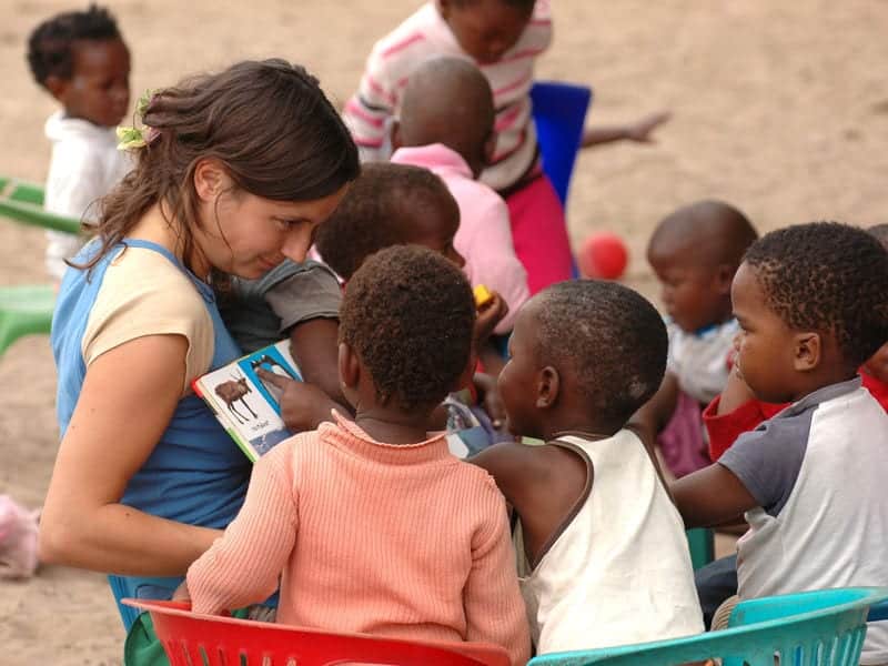 women reading children a book - CapeTown © Global Family Travels - Volunteer Family Vacations Every Member Will Love