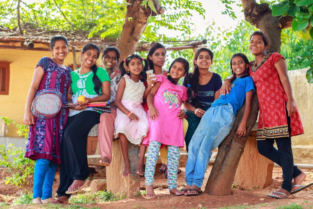 young girls posing together - Volunteer Family Vacations Every Member Will Love