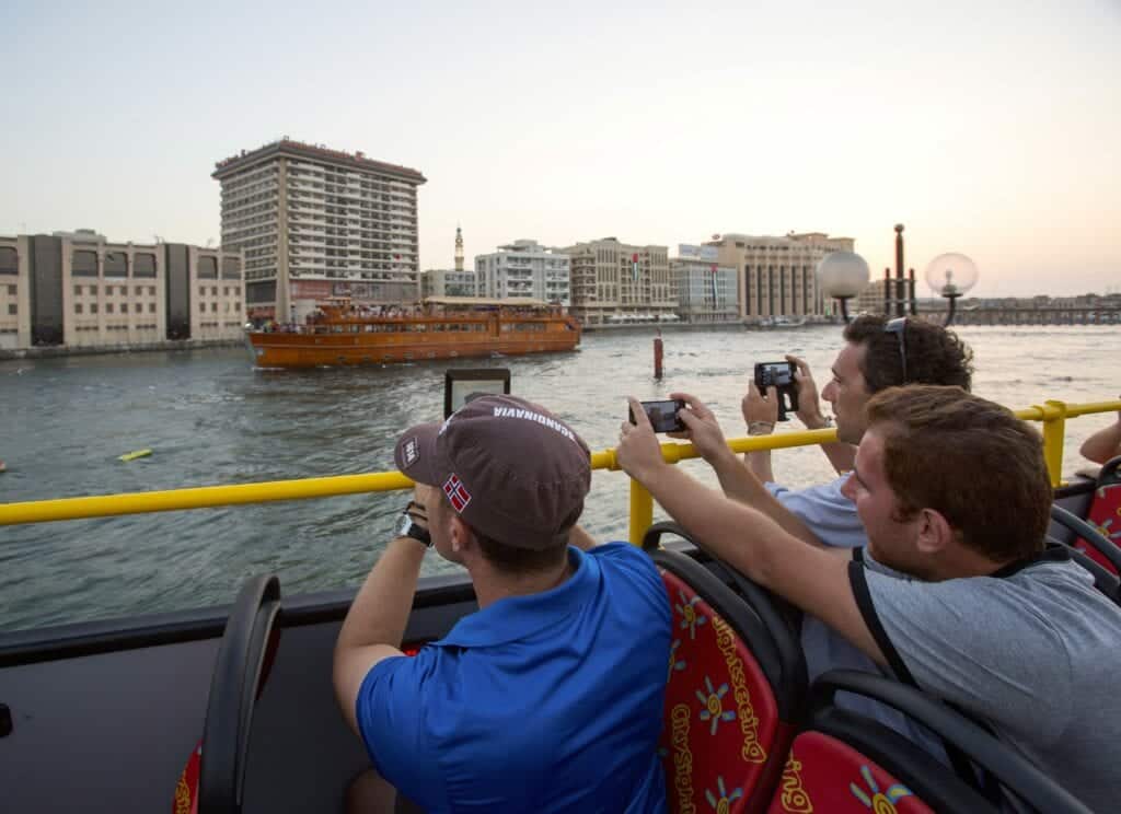 tourists taking photos on hop on hop off bus - Photo courtesy of isango! - Hop On - Hop Off Bus Tours: An Affordable Way to Travel with Kids