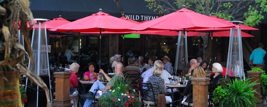 people eating under red umbrellas - Best Food in the North Carolina Mountains
