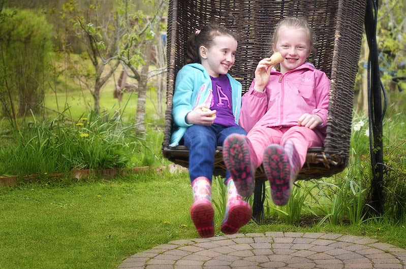 2 girls on swing - Exploring Celtic Gardens in Galway With Kids