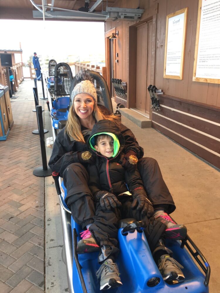 mother and son on sled ride - things to do in vail with kids - Sonnenalp Hotel in Vail, Colorado