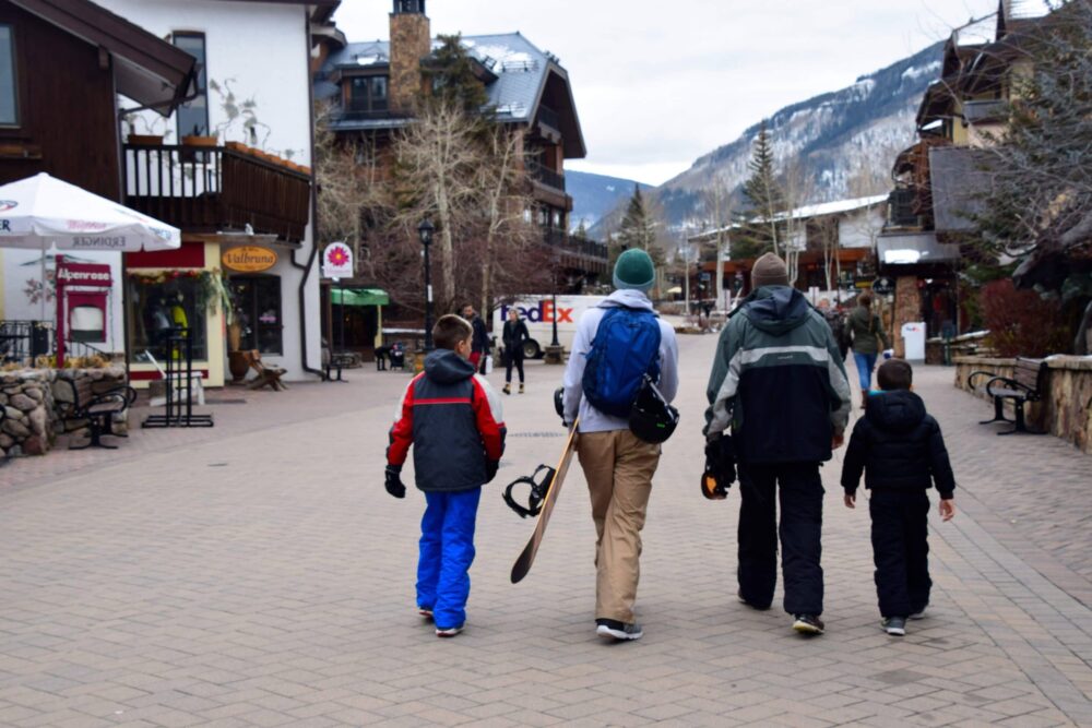 father and sons walking away with snow gear - fun stuff to do in Vail, colorado with kids