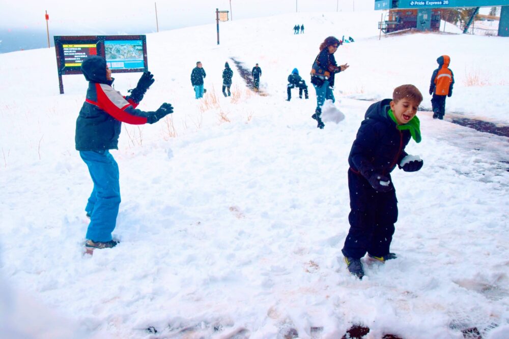 brother throwing snow at younger brother - things to do in vail with kids