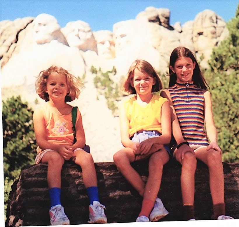 Girls in front of Mt. Rushmore - (Family) Travel In the Time of Corona