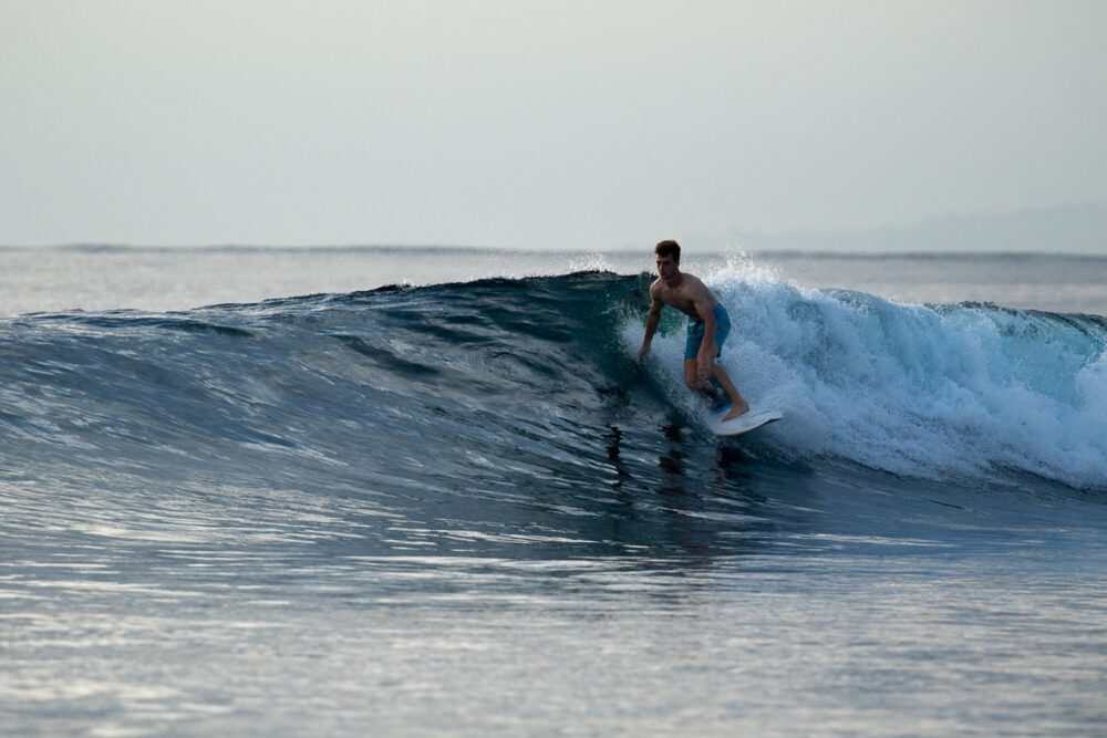 Surfing a wave with the team at Hidden Bay Resort Mentawais - Surfing Indonesia - The Best Family Surf Trip