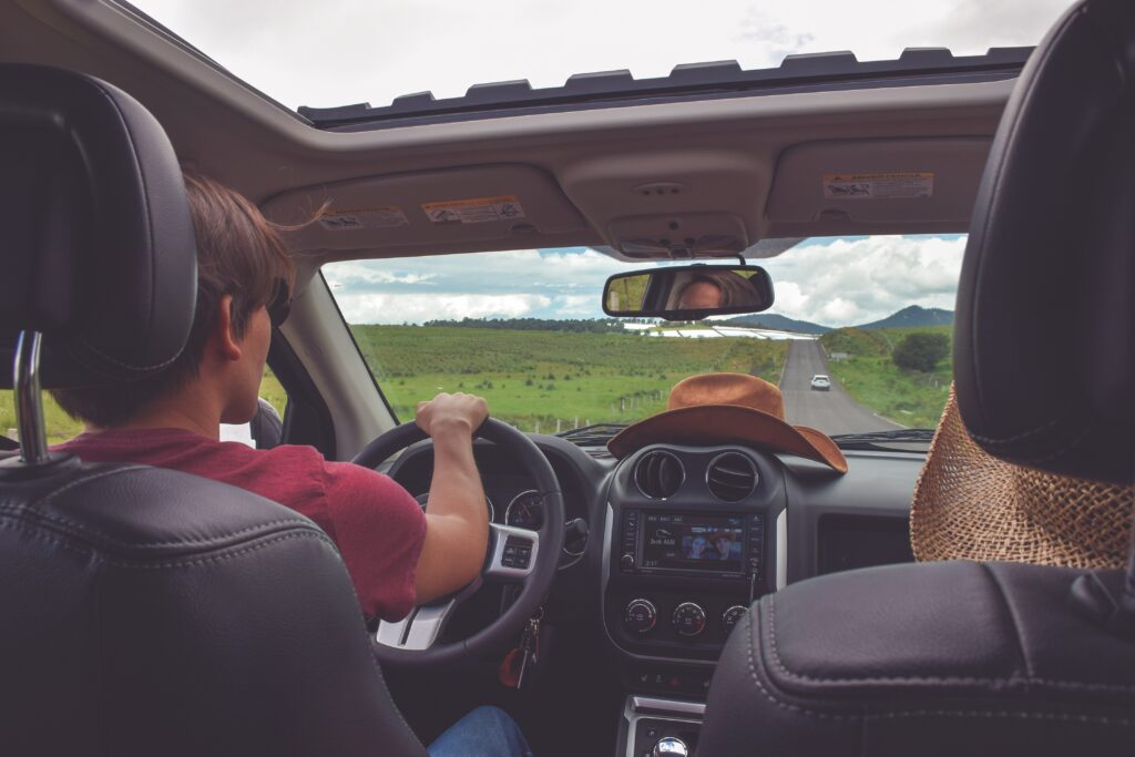 Boy driving car - 7 Tips for Surviving a Road Trip With Kids
