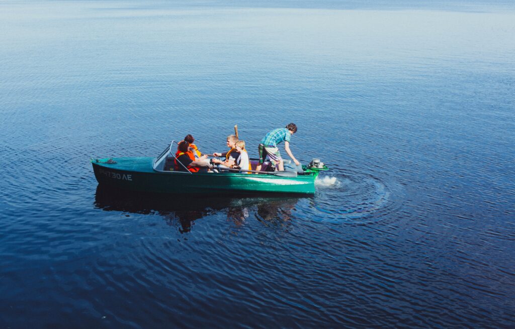 kids in a boat - 5 Can't Miss Tips for Traveling With Your Kids During COVID