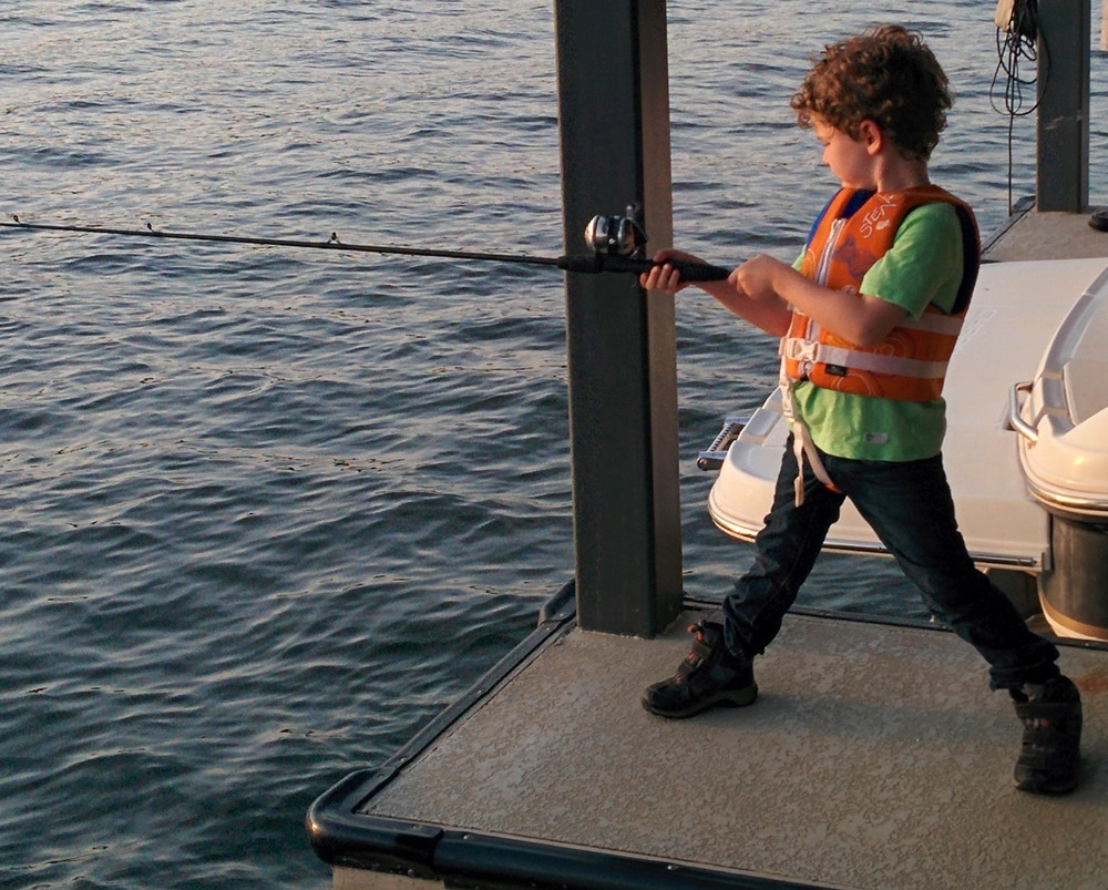 Kid fishing - 7 Essential Stops on a Family Summer Texas Road Trip