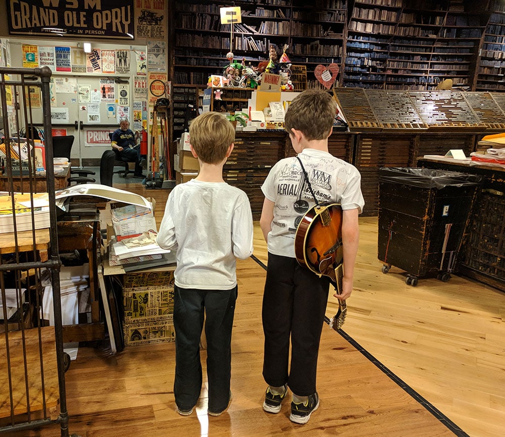 kids standing with guitars - things to do in nashville with kids