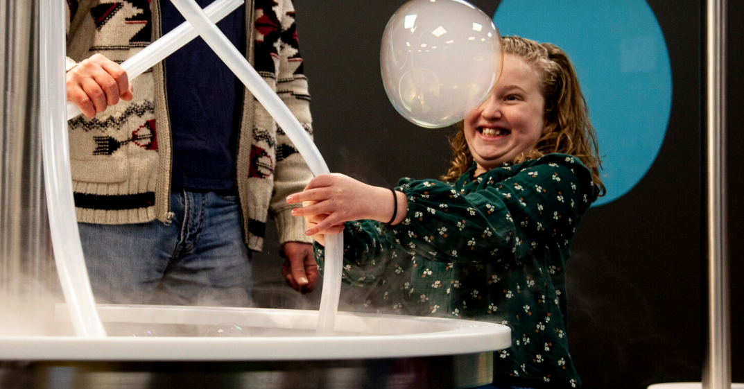 Girl with big bubble in front of her face. Things to do in Cleveland, OH with kids. 