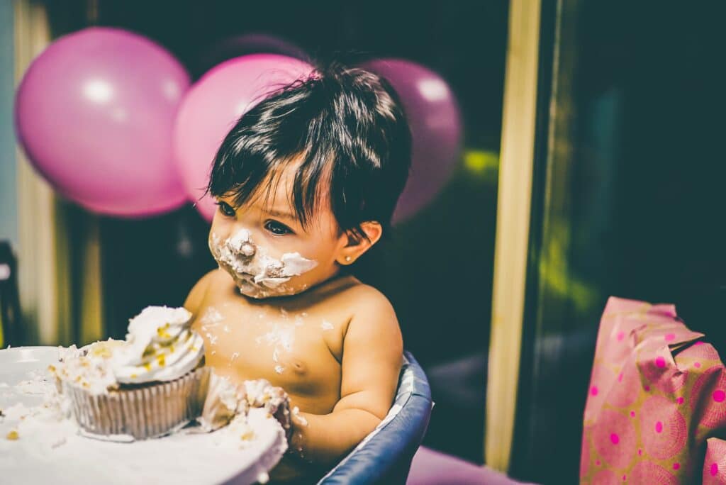 Baby eating cake - 6 Tips to Survive your First Hotel Stay with a Baby
