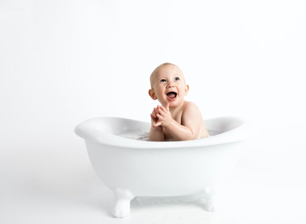Baby in a bathtub - 6 Tips to Survive your First Hotel Stay with a Baby