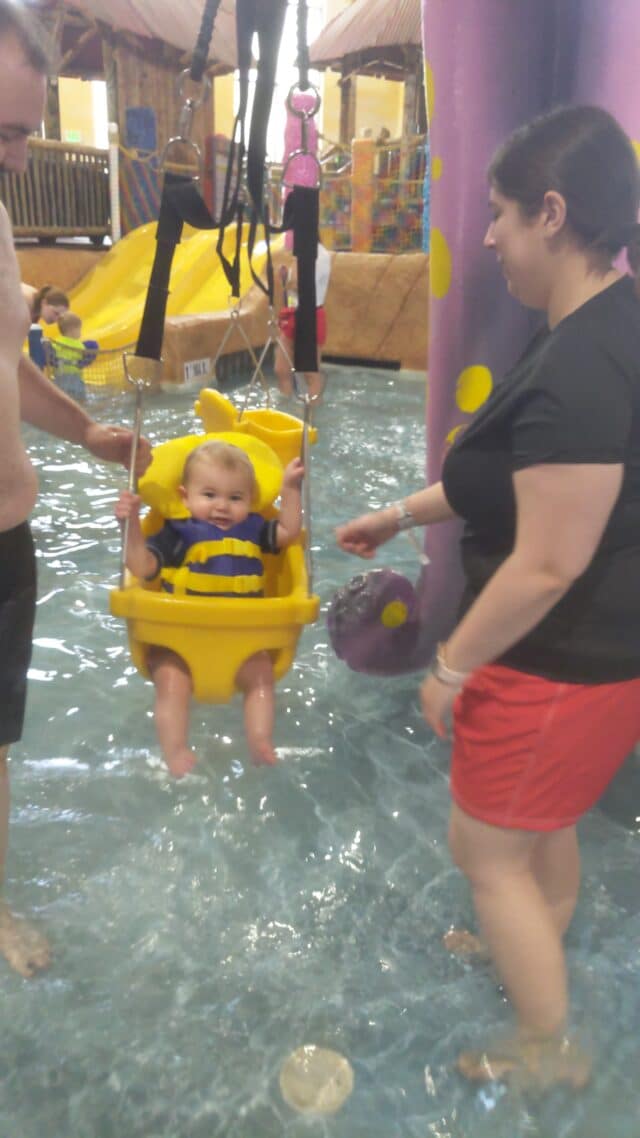 photo of toddler swing over a shallow pool.