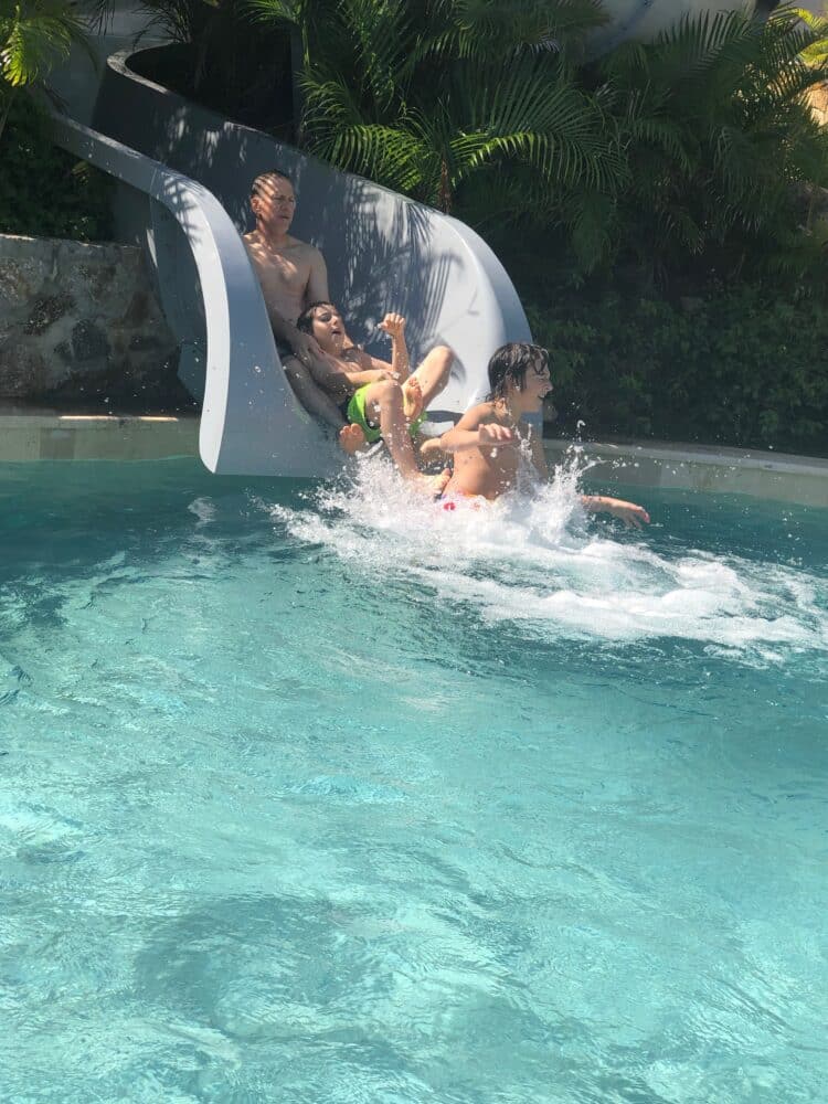 going down the waterslide at conrad punta de mita resort in mexico - riviera nayarit