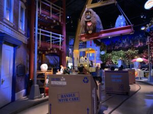 Riders board cardboard box-shaped vehicles in the apartment building's mailroom -