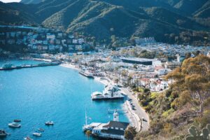 Aerial view of Catalina Island, depicting the ocean, boats, hills, and colorful buildings. 7 Best Things to do on Catalina Island with Kids