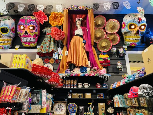 A statue of Frida Kahlo surrounded by painted skulls, sombreros, and other gift items. Things to do with kids in Sacramento.
