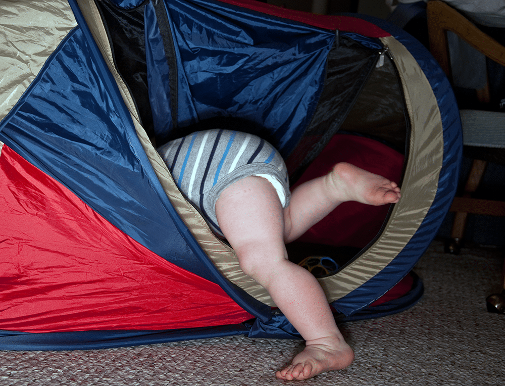 baby legs poking out of tent - baby travel hacks