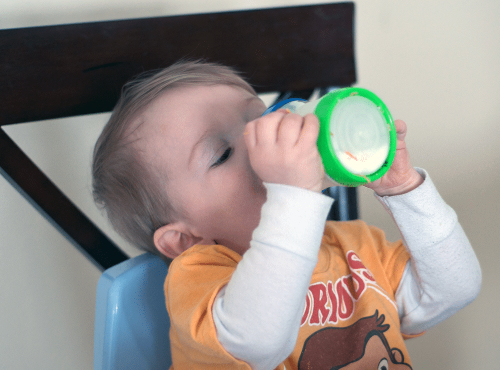 baby drinking from bottle - baby travel hacks