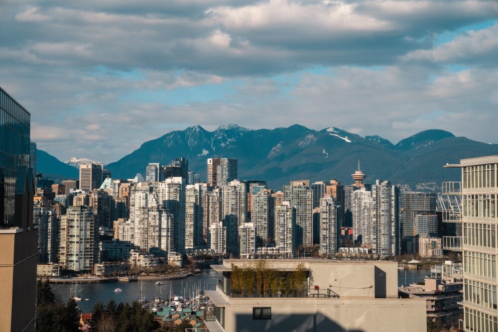 Vancouver skyline, with skyscrapers in the foreground and mountains behind. vancouver with kids how to spend the best long weekend family travel