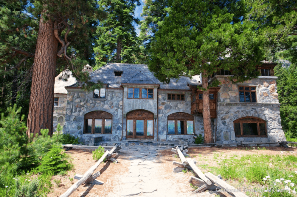 Front view of Vikingsholm, a stone mansion. Pine trees surround it.7 Not To Miss Things To Do In South Lake Tahoe With Kids family travel