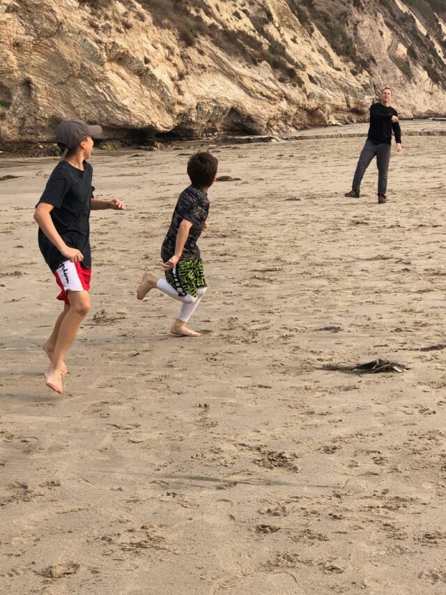 Boys throwing football on beach - The beautiful coastal city of Santa Barbara has lots of fun adult activities but there is a lot of fun to be had in Santa Barbara with kids!