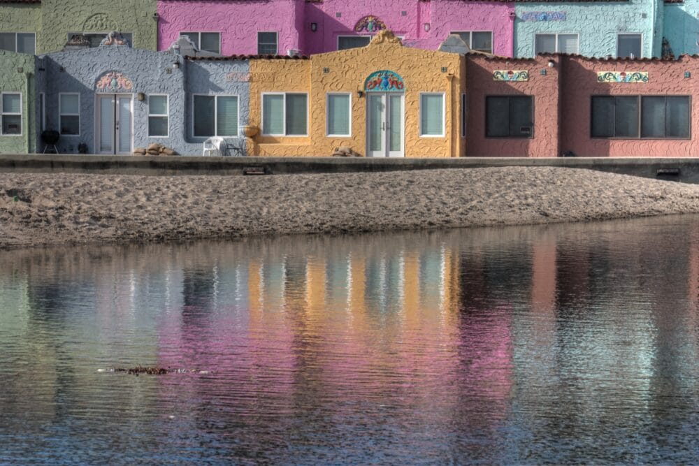 Pastel-colored buildings, with a pond in front. Best things to do with kids in Santa Cruz family travel 