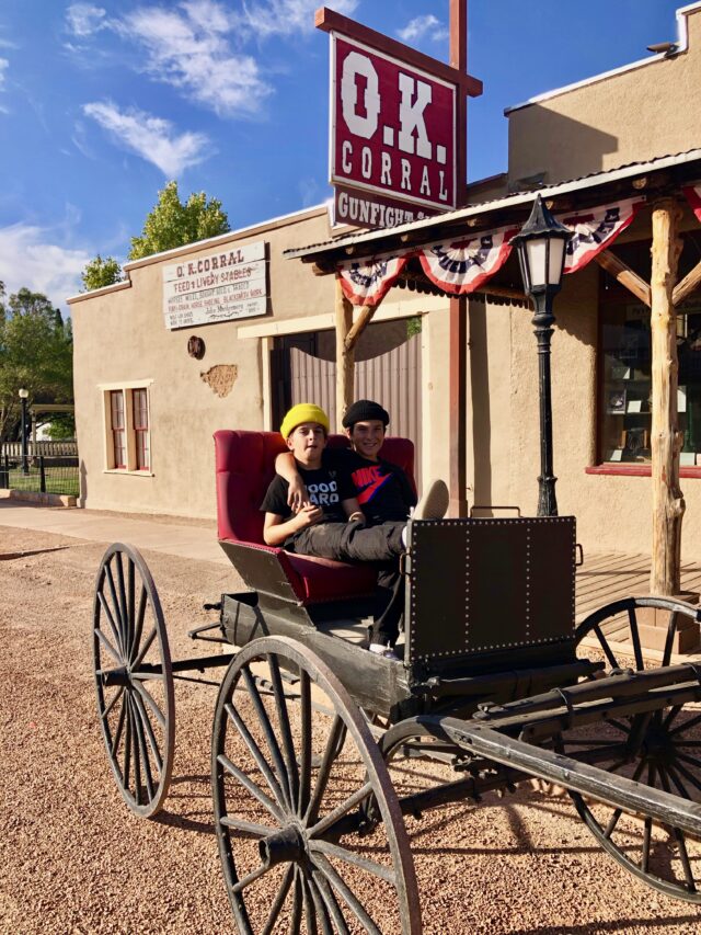 Boys in stagecoach at ok corral - things to do in Tombstone with kids