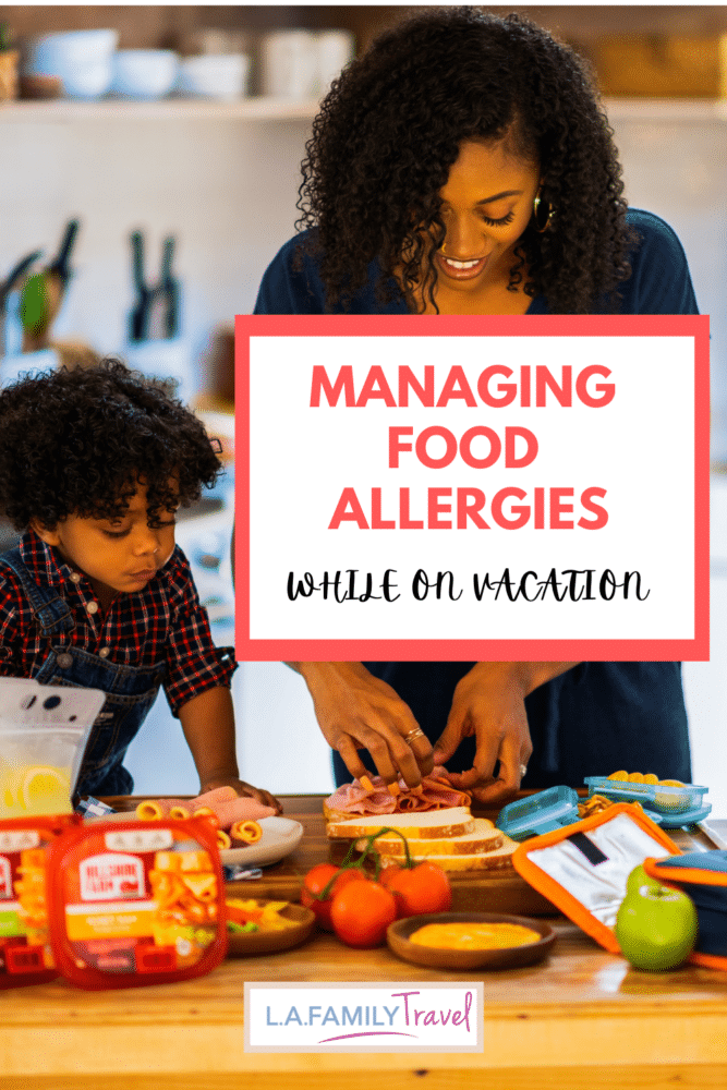 A mother and two sons prepare sandwiches and other snacks on a kitchen countertop. managing food allergies while on vacation