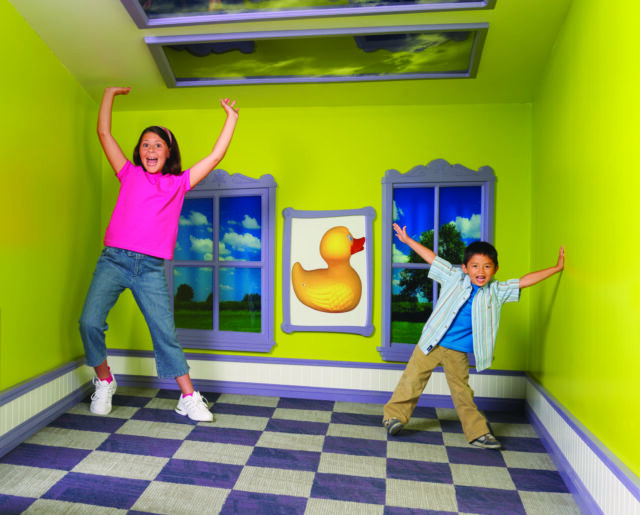 photo of kids playing in slanted house - ROCHESTER New York is full of fun things to do for kids of all ages. Here are the best ones like Niagra Falls, Genesse Country Village and the Seneca Park zoo. 