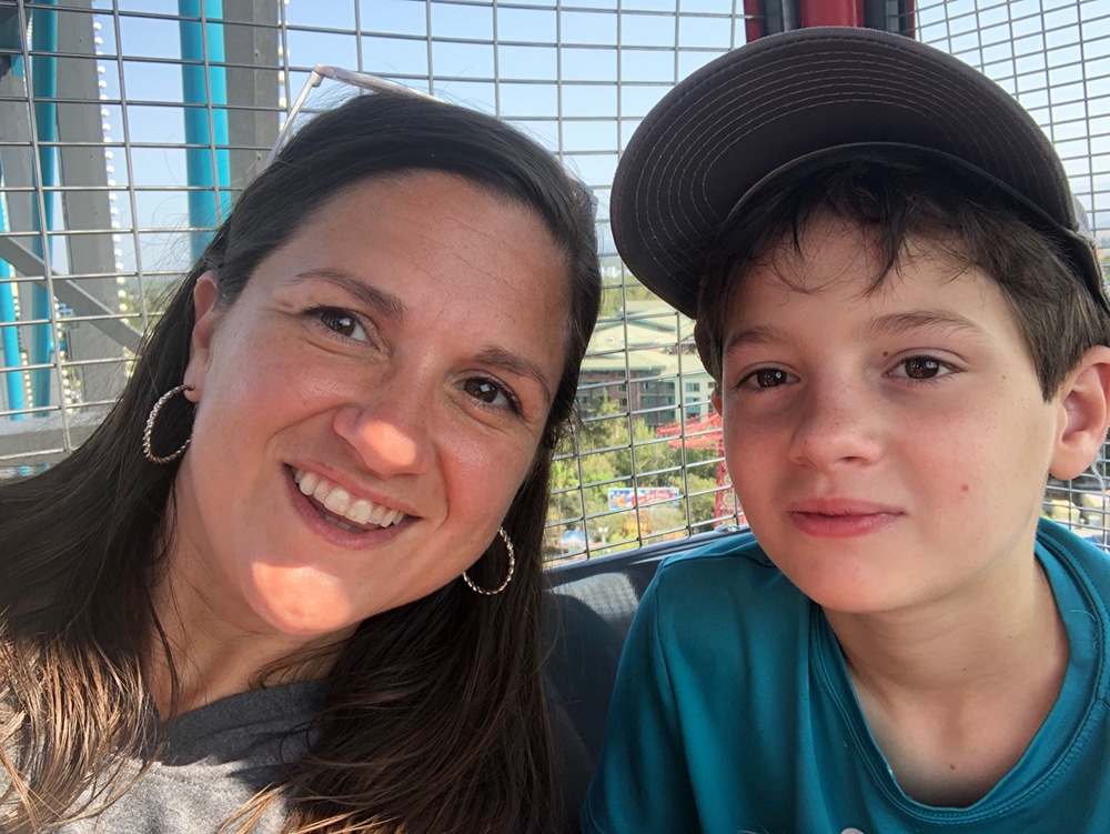 A mom and son at the top of a ferris wheel. Vacation anxiety and travel anxiety require slowing down and listening.