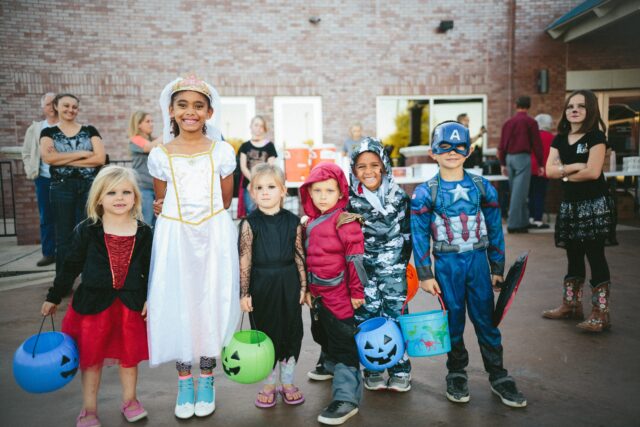 Children dressed on costumes smile at the camera. Fall in the San Francisco Bay Area: Best Things to Do with Kids family travel halloween