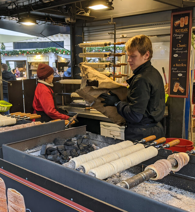 Stick bread being made at a Christmas market in Prague.