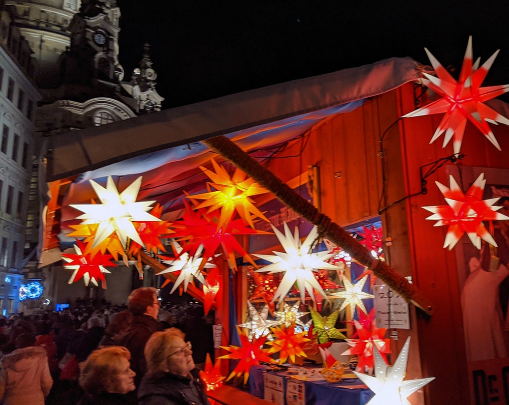 Moravian Stars decorate a wooden booth at a Christmas market in Dresden.