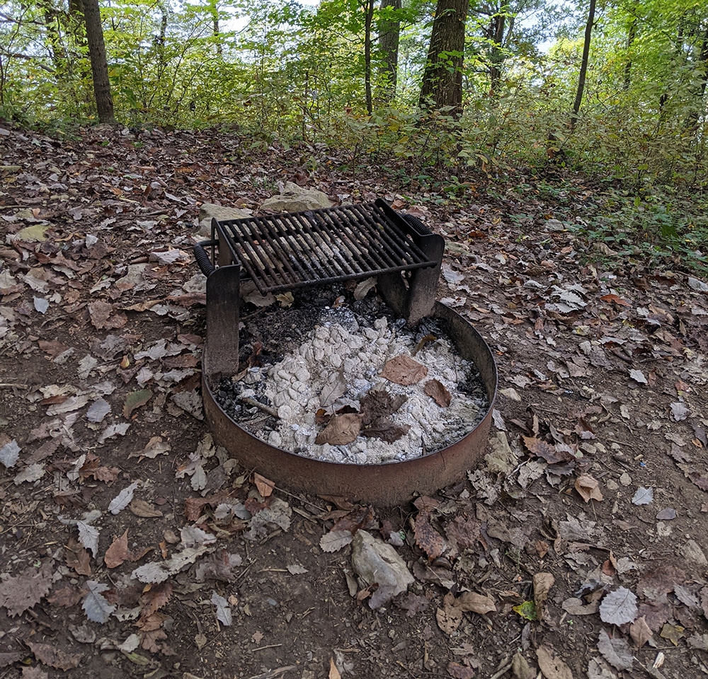 A dilapidated grill in a campsite. Beginnger campers should come prepared for all conditions. Camping tips. 