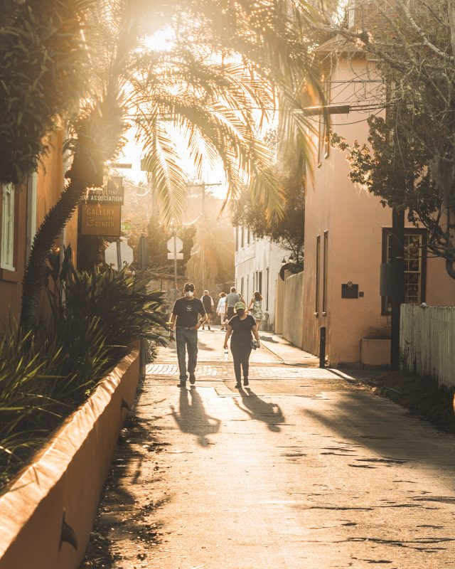 People walking down small alleyway