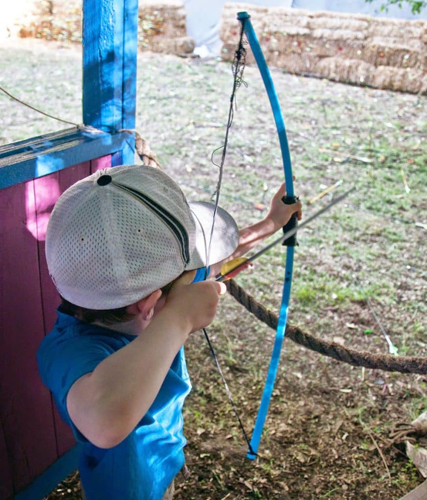 A young boy tries archery at the Tennessee Renaissance Festival. 